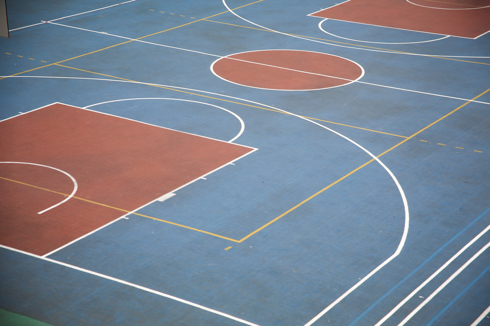 Depositphotos_213705696_S Newly designed basketball court in Orlando featuring professional-grade flooring and modern hoop installations by Coastal Courts